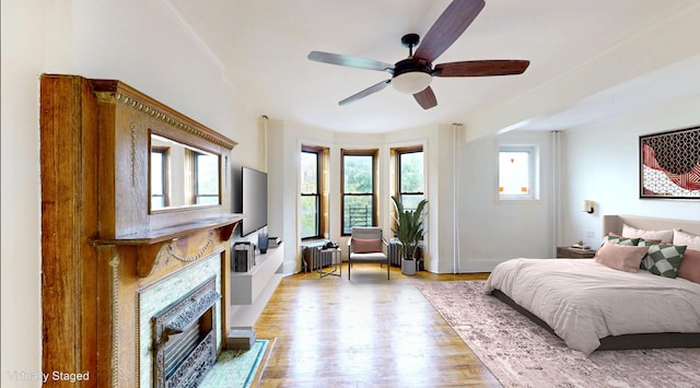 93A Rutland Rd, New York City, NY 11225 - bedroom with a fireplace with flush hearth, radiator, light wood-style flooring, and ceiling fan