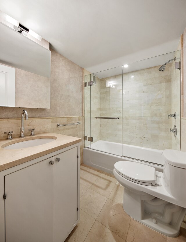 200 E 66th St Unit B904, New York City, NY 10065 - full bathroom featuring toilet, shower / washtub combination, vanity, and tile walls