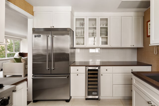 200 E 66th St Unit B904, New York City, NY 10065 - kitchen featuring built in fridge, wine cooler, dark countertops, and white cabinets