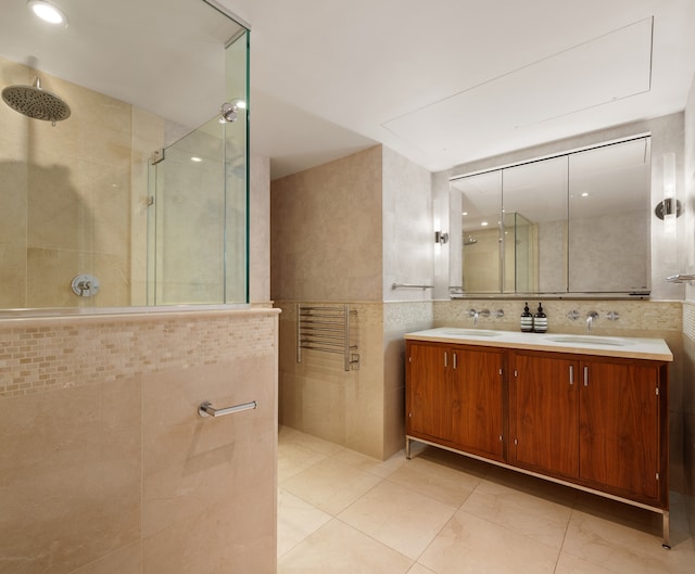 200 E 66th St Unit B904, New York City, NY 10065 - bathroom featuring tile walls, walk in shower, double vanity, and recessed lighting