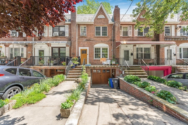 3226 Irwin Ave, New York City, NY 10463 - view of property with a garage, concrete driveway, brick siding, and a chimney