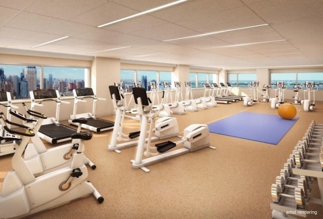 322 W 57th St Unit 33P2, New York City, NY 10019 - gym featuring a drop ceiling and healthy amount of natural light