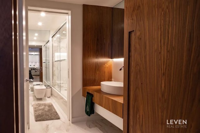 322 W 57th St Unit 33P2, New York City, NY 10019 - bathroom featuring marble finish flooring, vanity, and recessed lighting