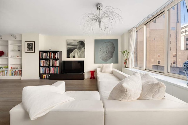170 E 87th St Unit W8D, New York City, NY 10028 - living area with a chandelier, wood finished floors, and built in shelves