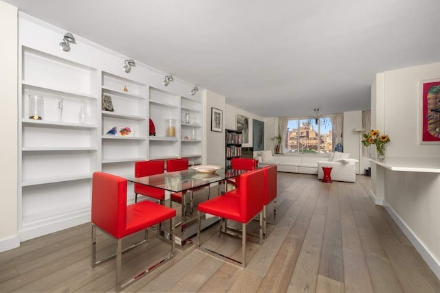 170 E 87th St Unit W8D, New York City, NY 10028 - dining area featuring wood-type flooring, baseboards, and built in features