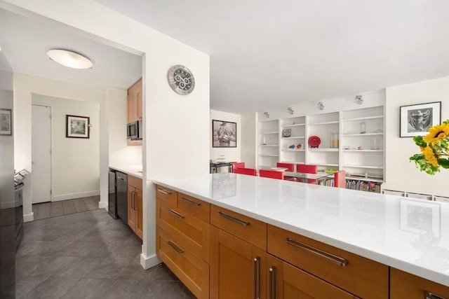 170 E 87th St Unit W8D, New York City, NY 10028 - kitchen with stainless steel microwave, light countertops, open shelves, and baseboards