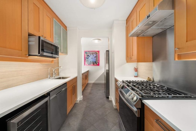 170 E 87th St Unit W8D, New York City, NY 10028 - kitchen featuring appliances with stainless steel finishes, a sink, under cabinet range hood, backsplash, and light countertops