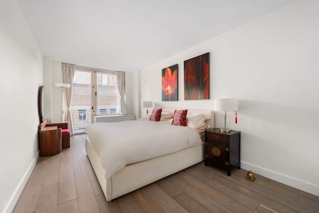 170 E 87th St Unit W8D, New York City, NY 10028 - bedroom featuring access to outside, wood-type flooring, and baseboards