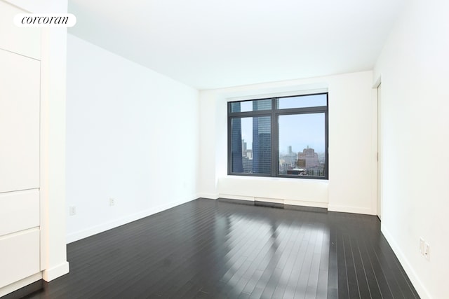 123 Washington St Unit 35E, New York City, NY 10006 - empty room featuring dark wood-type flooring and baseboards