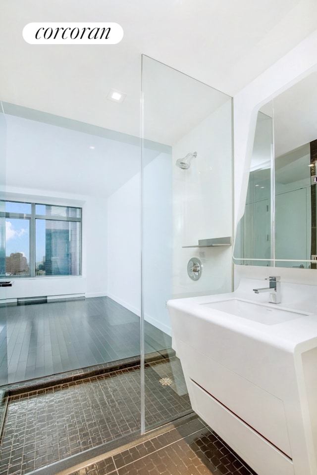 123 Washington St Unit 35E, New York City, NY 10006 - bathroom featuring vanity, a shower, and baseboards