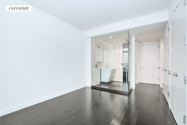 123 Washington St Unit 35E, New York City, NY 10006 - unfurnished room with dark wood-type flooring and baseboards