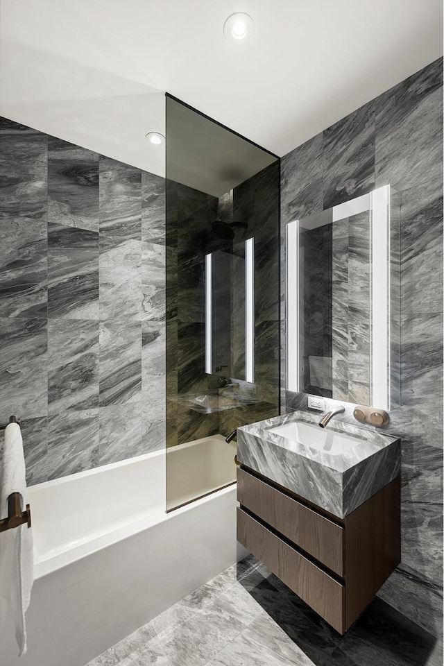 130 William St Unit 10-F, New York City, NY 10038 - bathroom with vanity, washtub / shower combination, tile walls, and recessed lighting