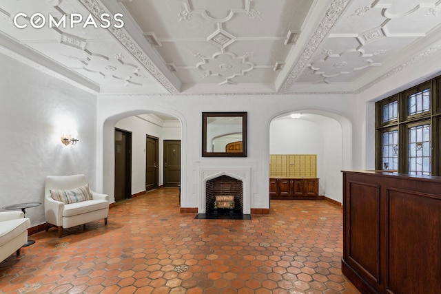 40 W 67th St Unit 1A, New York City, NY 10023 - unfurnished living room with arched walkways, baseboards, crown molding, and a premium fireplace
