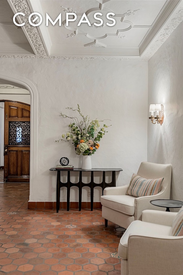 40 W 67th St Unit 1A, New York City, NY 10023 - living area with crown molding, a textured wall, and baseboards