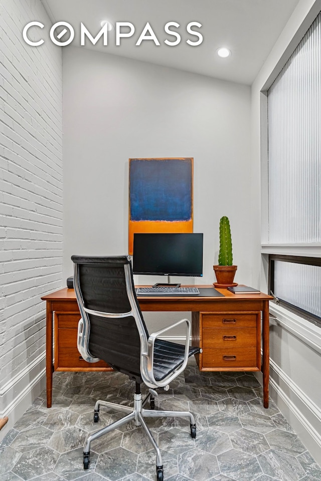 40 W 67th St Unit 1A, New York City, NY 10023 - office space featuring stone finish floors, baseboards, and brick wall