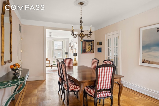 37-28 80th St Unit 32, New York City, NY 11372 - dining area with baseboards and a chandelier