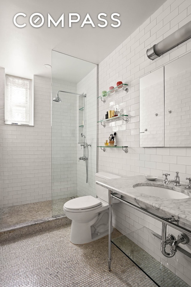 37-28 80th St Unit 32, New York City, NY 11372 - bathroom with tile walls, a tile shower, and tile patterned flooring