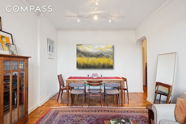 158-18 Riverside Dr W Unit 2M, New York City, NY 10032 - dining room featuring arched walkways, ornamental molding, baseboards, and rail lighting