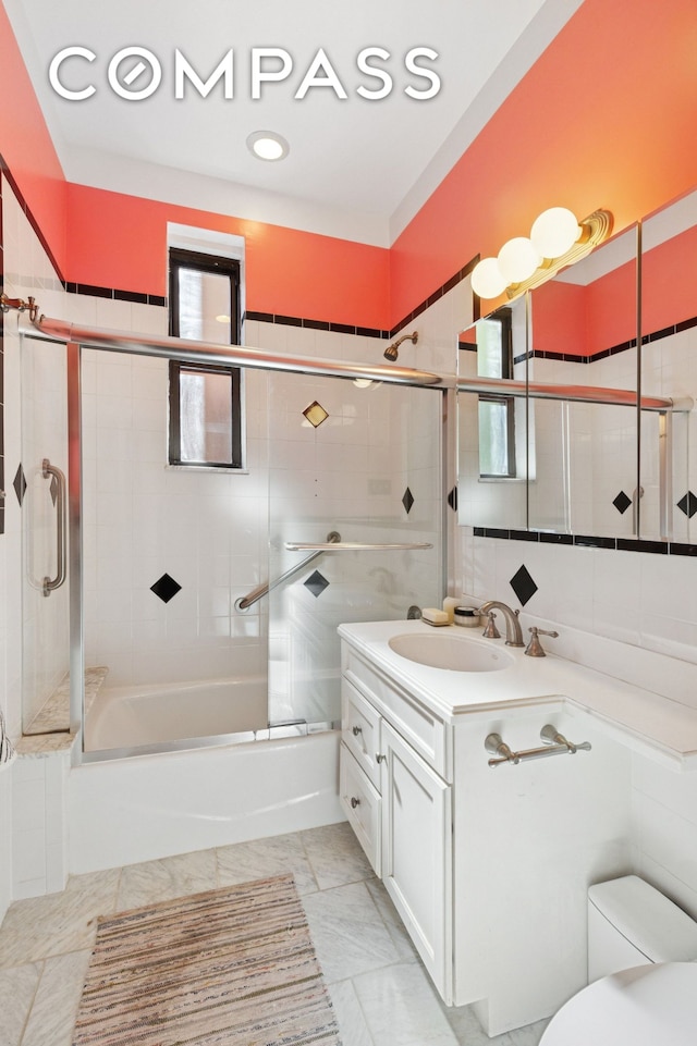 158-18 Riverside Dr W Unit 2M, New York City, NY 10032 - bathroom featuring vanity, bath / shower combo with glass door, toilet, and marble finish flooring