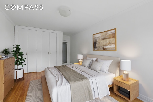 400 E 17th St Unit 711, New York City, NY 11226 - bedroom with light wood-style floors, multiple closets, and crown molding