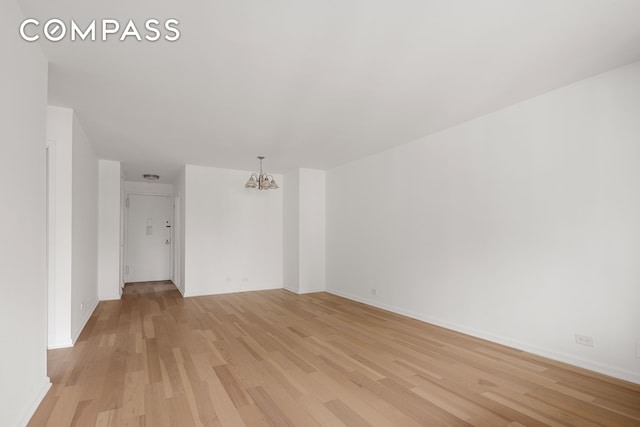 201 W 70th St Unit 8L, New York City, NY 10023 - unfurnished room with a chandelier and light wood finished floors