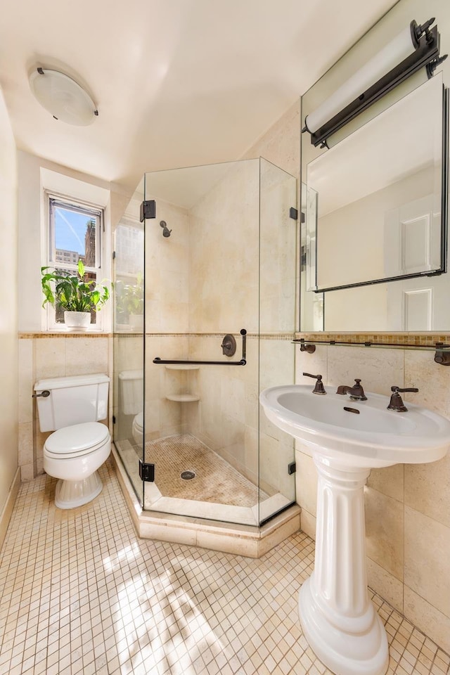 1 Lexington Ave Unit 1/2D, New York City, NY 10010 - full bathroom featuring tile walls, toilet, tile patterned floors, and a shower stall