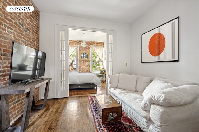 77 Perry St Unit 4C, New York City, NY 10014 - living room featuring brick wall and wood-type flooring