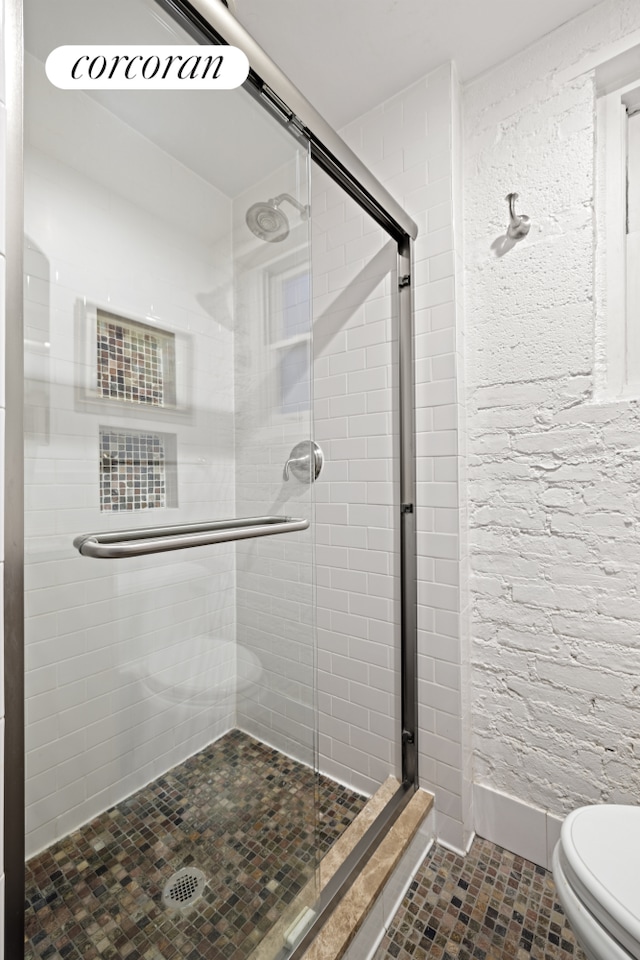 77 Perry St Unit 4C, New York City, NY 10014 - bathroom with toilet, a shower stall, and tile patterned flooring