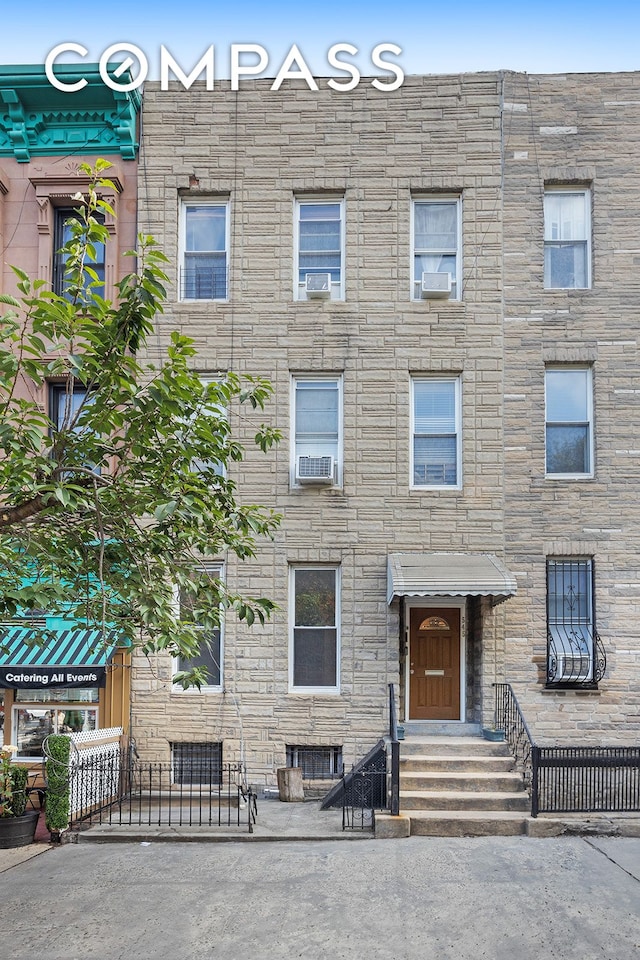545 10th St, New York City, NY 11215 - view of front of house featuring stone siding, entry steps, and cooling unit