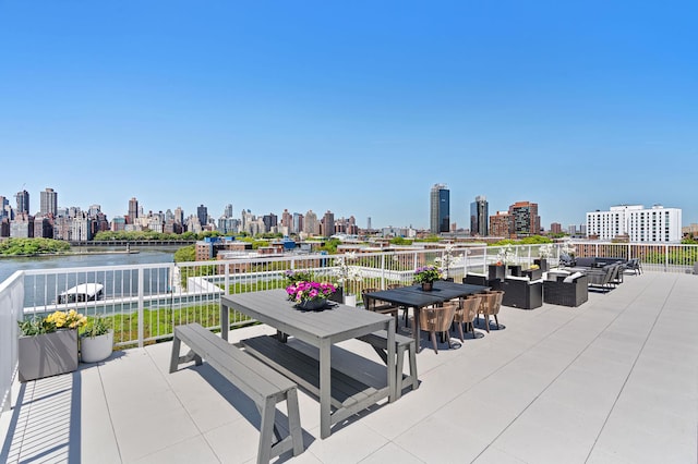 30-05 Vernon Blvd Unit 5-D, New York City, NY 11102 - view of patio with an outdoor living space, a view of skyline, a water view, and outdoor dining space