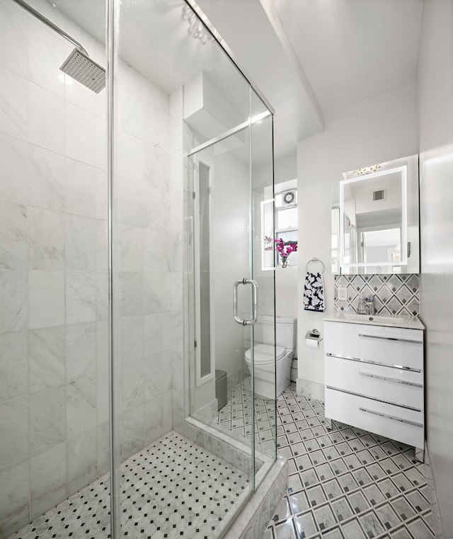 10 W 86th St Unit 15A, New York City, NY 10024 - bathroom with toilet, vanity, a shower stall, and tile patterned floors
