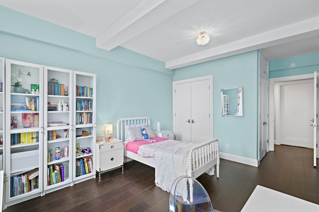 10 W 86th St Unit 15A, New York City, NY 10024 - bedroom with beam ceiling, dark wood-style flooring, a closet, and baseboards