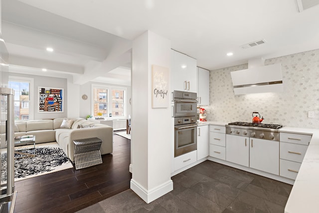 10 W 86th St Unit 15A, New York City, NY 10024 - kitchen with appliances with stainless steel finishes, plenty of natural light, light countertops, recessed lighting, and beamed ceiling
