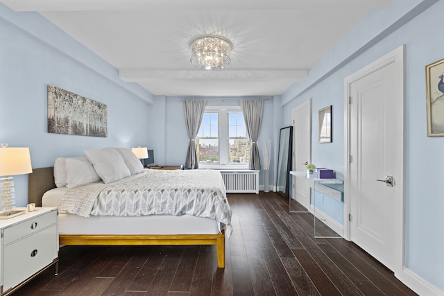 10 W 86th St Unit 15A, New York City, NY 10024 - bedroom with radiator heating unit, beamed ceiling, hardwood / wood-style flooring, baseboards, and a chandelier