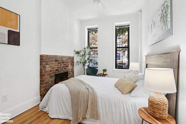 354 Baltic St Unit 2, New York City, NY 11201 - bedroom featuring wood finished floors, baseboards, and a fireplace