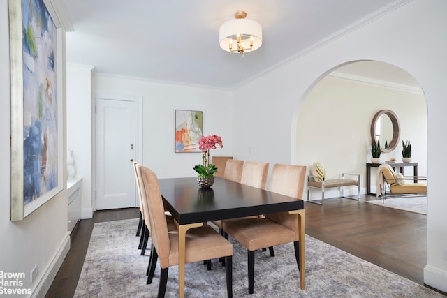 970 Park Ave Unit 8N, New York City, NY 10028 - dining room featuring wood finished floors, arched walkways, crown molding, a chandelier, and baseboards