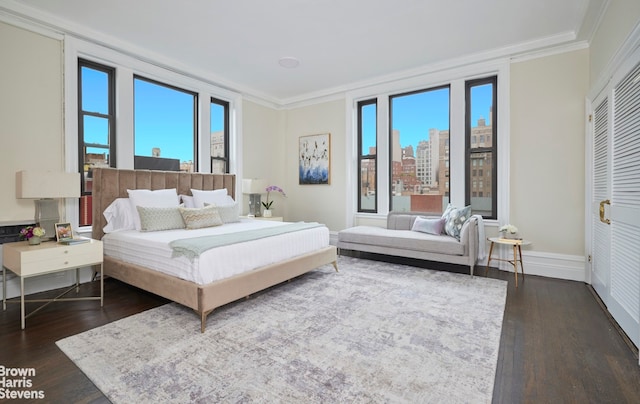 970 Park Ave Unit 8N, New York City, NY 10028 - bedroom with dark wood-style floors, multiple windows, crown molding, and a view of city
