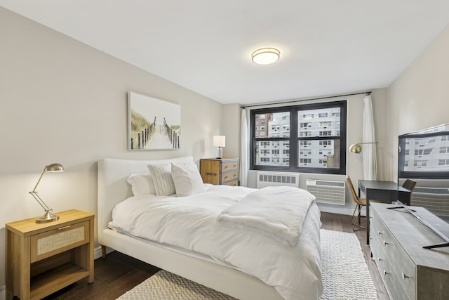 315 E 70th St Unit 9A, New York City, NY 10021 - bedroom featuring dark wood-type flooring, radiator, and a wall mounted air conditioner