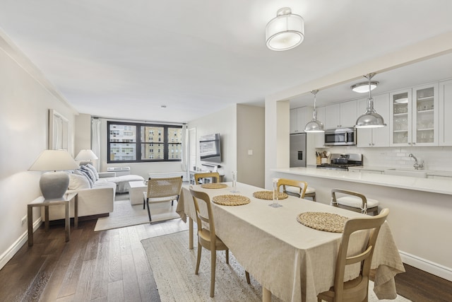 315 E 70th St Unit 9A, New York City, NY 10021 - dining area featuring dark wood-style floors and baseboards