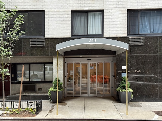 249 E 48th St Unit 3A, New York City, NY 10017 - doorway to property featuring brick siding