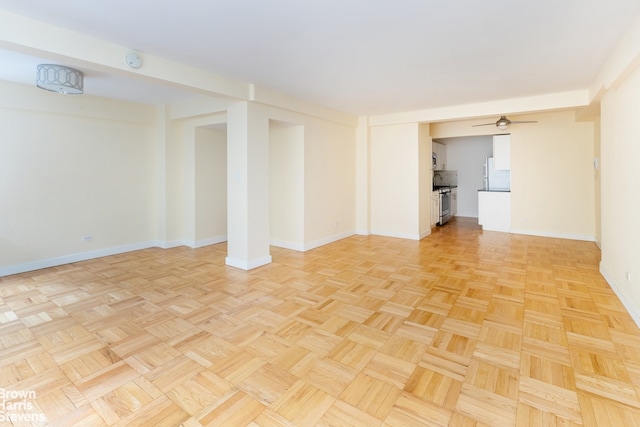 249 E 48th St Unit 3A, New York City, NY 10017 - spare room featuring baseboards and ceiling fan