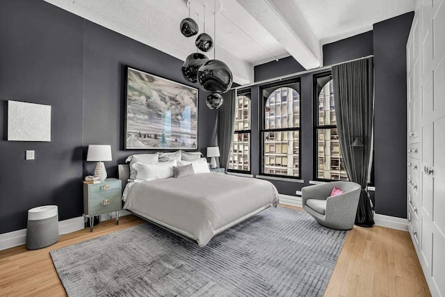 30 Main St Unit 11F, New York City, NY 11201 - bedroom with beam ceiling, wood finished floors, and baseboards