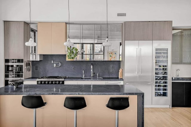 30 Main St Unit 11F, New York City, NY 11201 - kitchen with a sink, tasteful backsplash, stove, and a kitchen breakfast bar