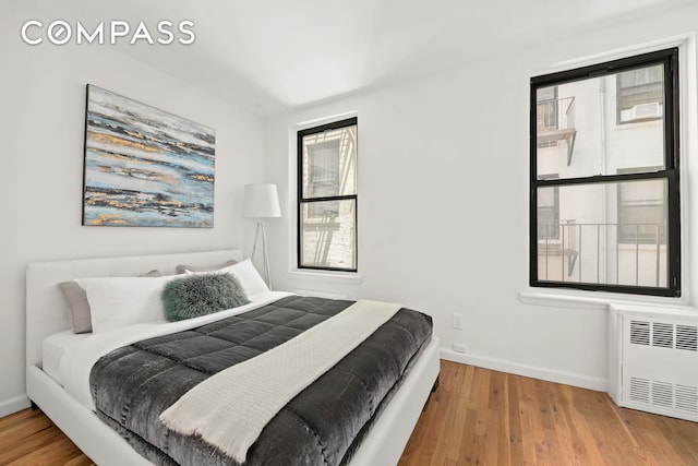 234 E 35th St Unit 3, New York City, NY 10016 - bedroom with radiator, baseboards, and wood finished floors