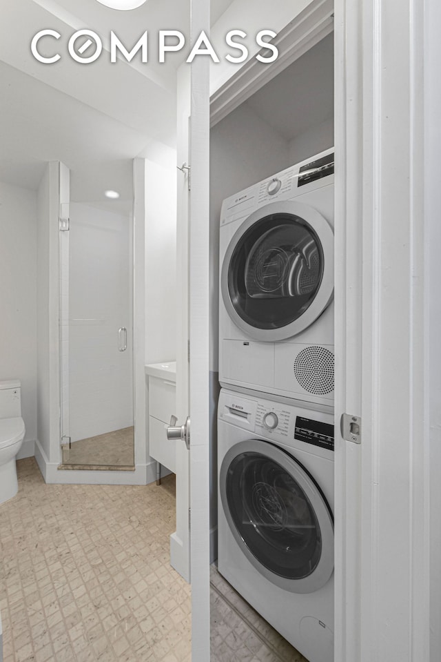 9511 Shore Rd Unit 505, New York City, NY 11209 - laundry room with stacked washing machine and dryer and tile patterned floors