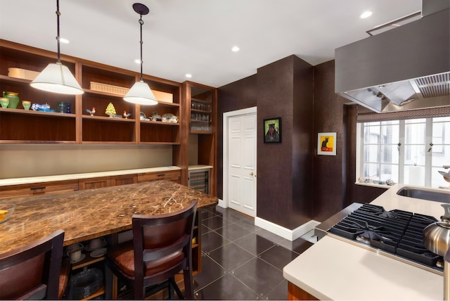 480 Park Ave Unit 15E, New York City, NY 10022 - kitchen featuring premium range hood, dark tile patterned floors, pendant lighting, baseboards, and a sink