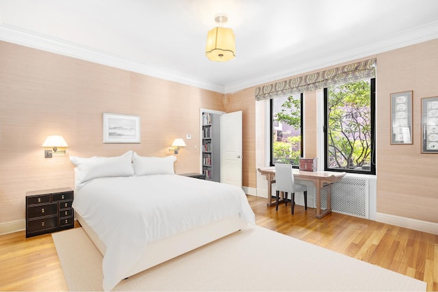 480 Park Ave Unit 15E, New York City, NY 10022 - bedroom with baseboards, ornamental molding, wood finished floors, and radiator