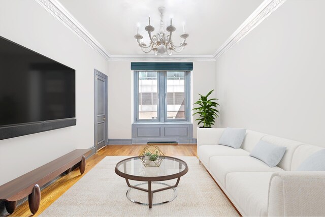 480 Park Ave Unit 15E, New York City, NY 10022 - living area with a chandelier, wood finished floors, ornamental molding, and baseboards