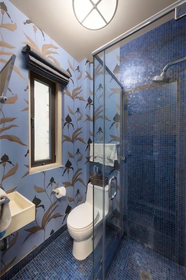 480 Park Ave Unit 15E, New York City, NY 10022 - full bath with wallpapered walls, toilet, a stall shower, and tile patterned floors