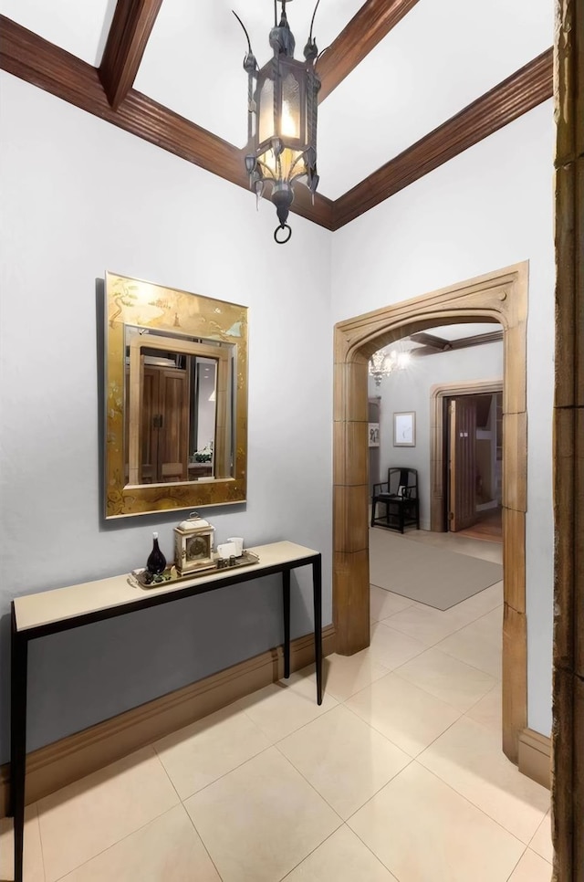 480 Park Ave Unit 15E, New York City, NY 10022 - corridor with arched walkways, crown molding, a chandelier, and light tile patterned floors
